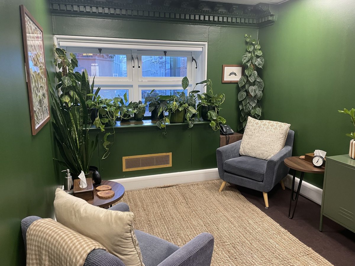 The consulting room at Token House: a quiet, plant-filled room with armchairs and a window onto Tokenhouse Yard